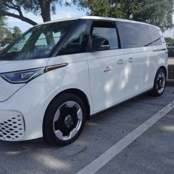 White Volkswagen ID.Buzz electric van parked in a lot.